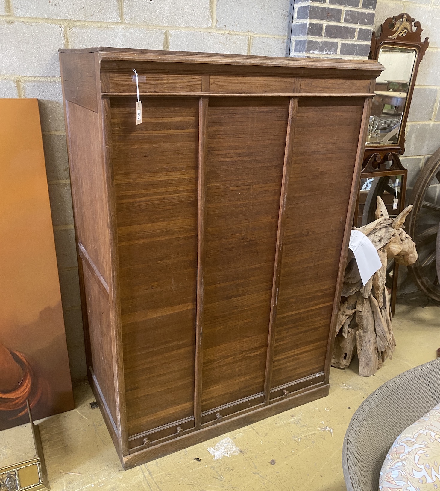 A mid century French oak triple tambour filing cabinet, width 118cm, depth 71cm, height 172cm
